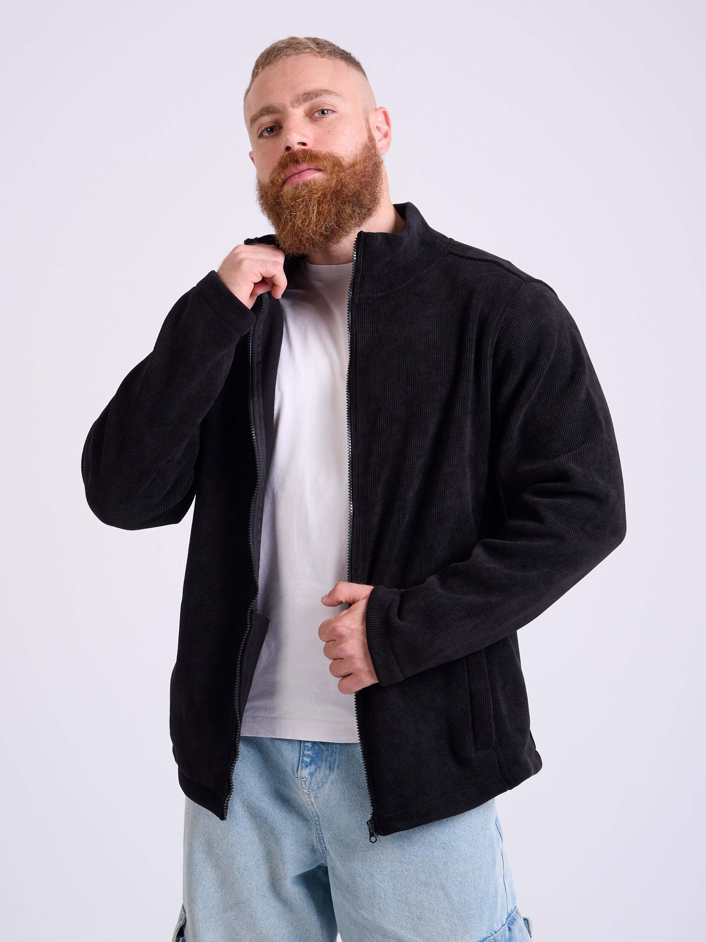 Man wearing a black corduroy jacket by KAF on a white background