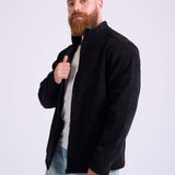 Man wearing a black corduroy jacket by KAF on a white background