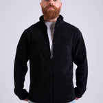 Man wearing a black corduroy jacket by KAF on a white background