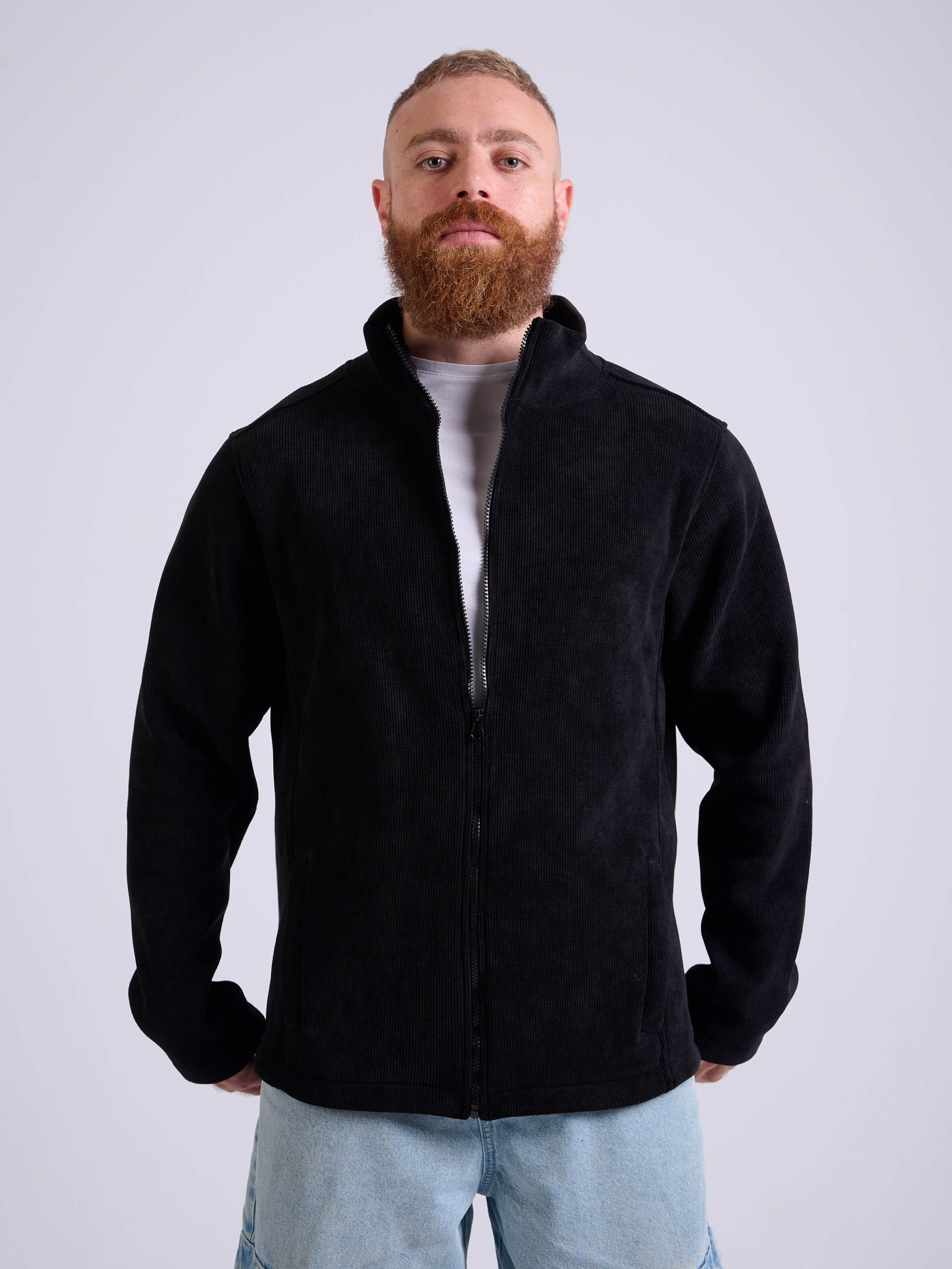 Man wearing a black corduroy jacket by KAF on a white background