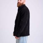 Man wearing a black corduroy jacket by KAF on a white background