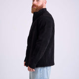 Man wearing a black corduroy jacket by KAF on a white background