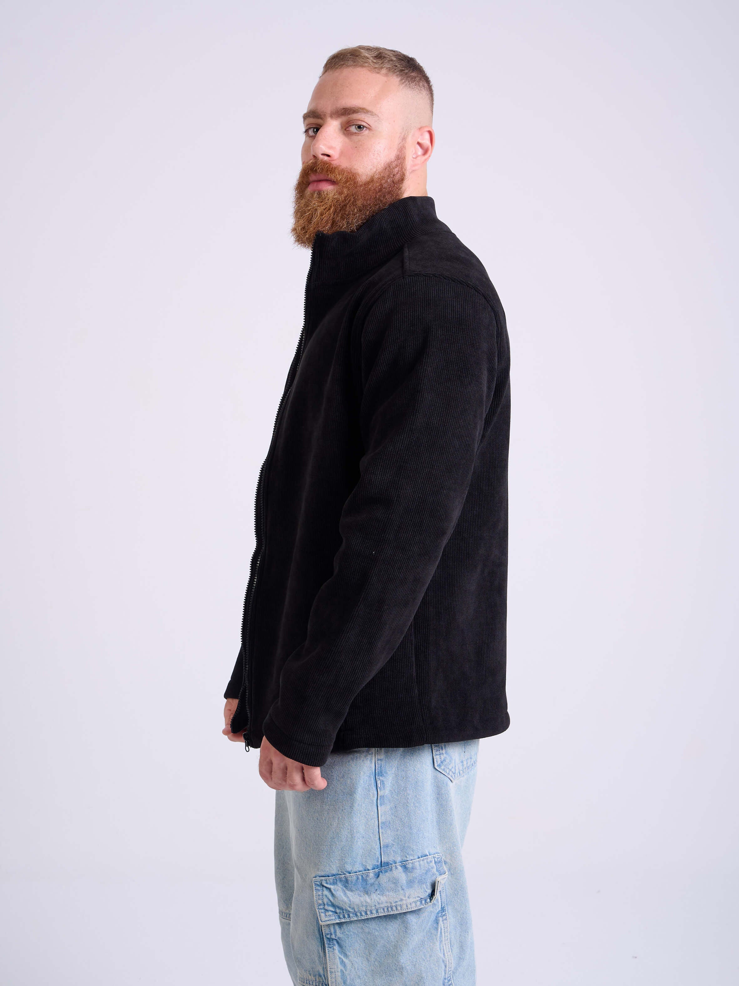Man wearing a black corduroy jacket by KAF on a white background