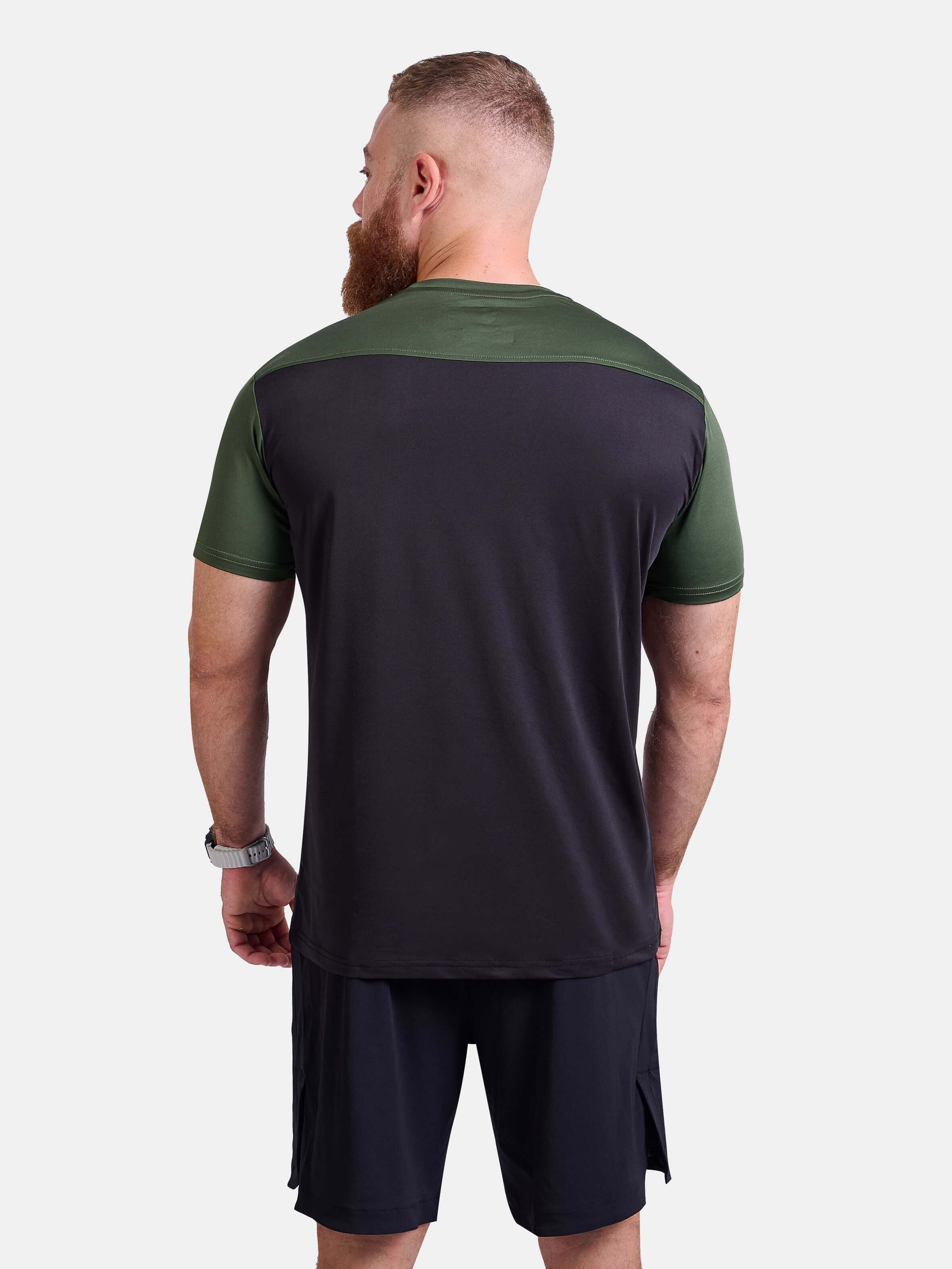 Man wearing black and green sports - gym - padel t-shirt by KAF Egypt