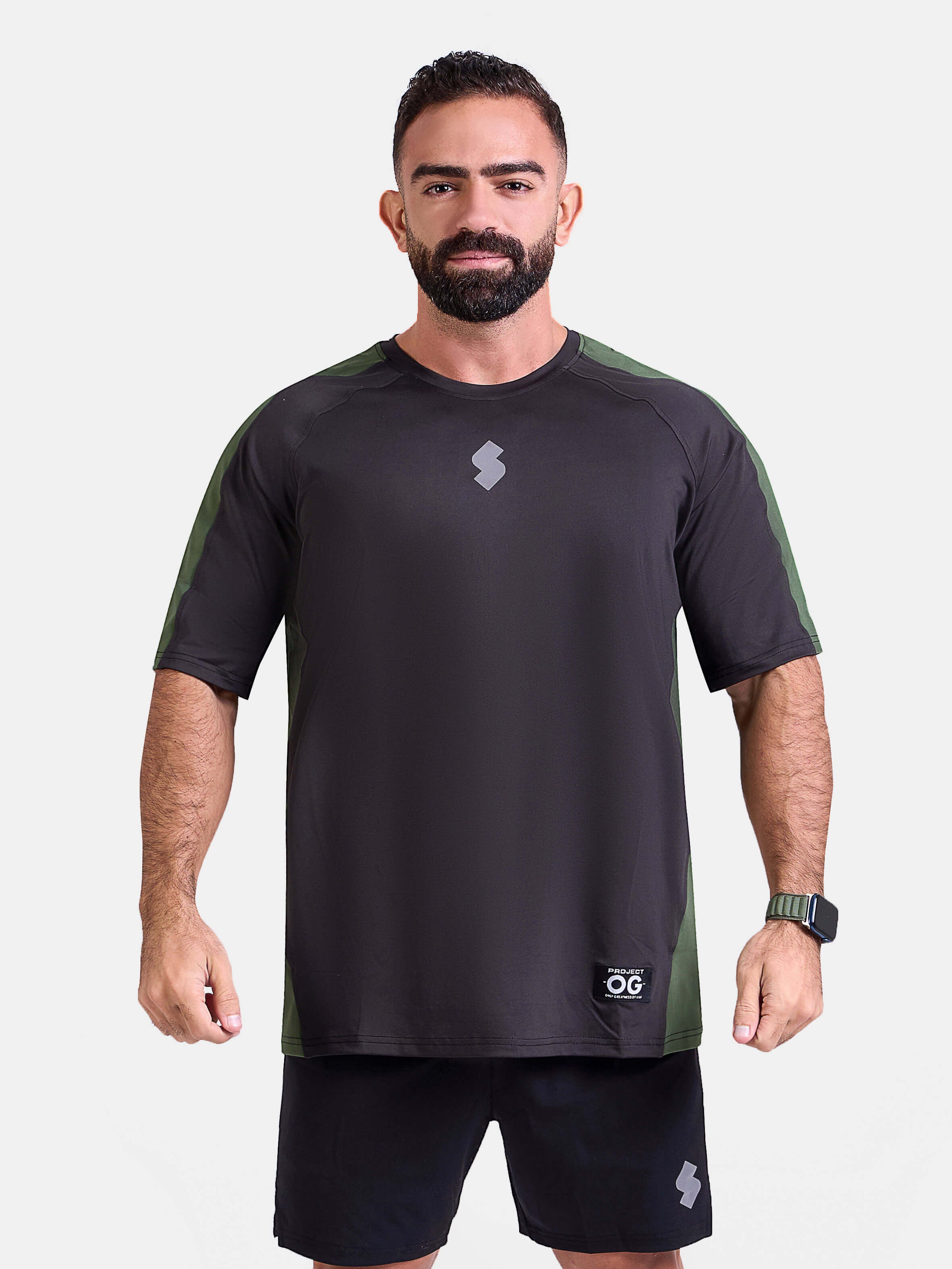 Man wearing a black and green oversized sports & gym shirt by KAF