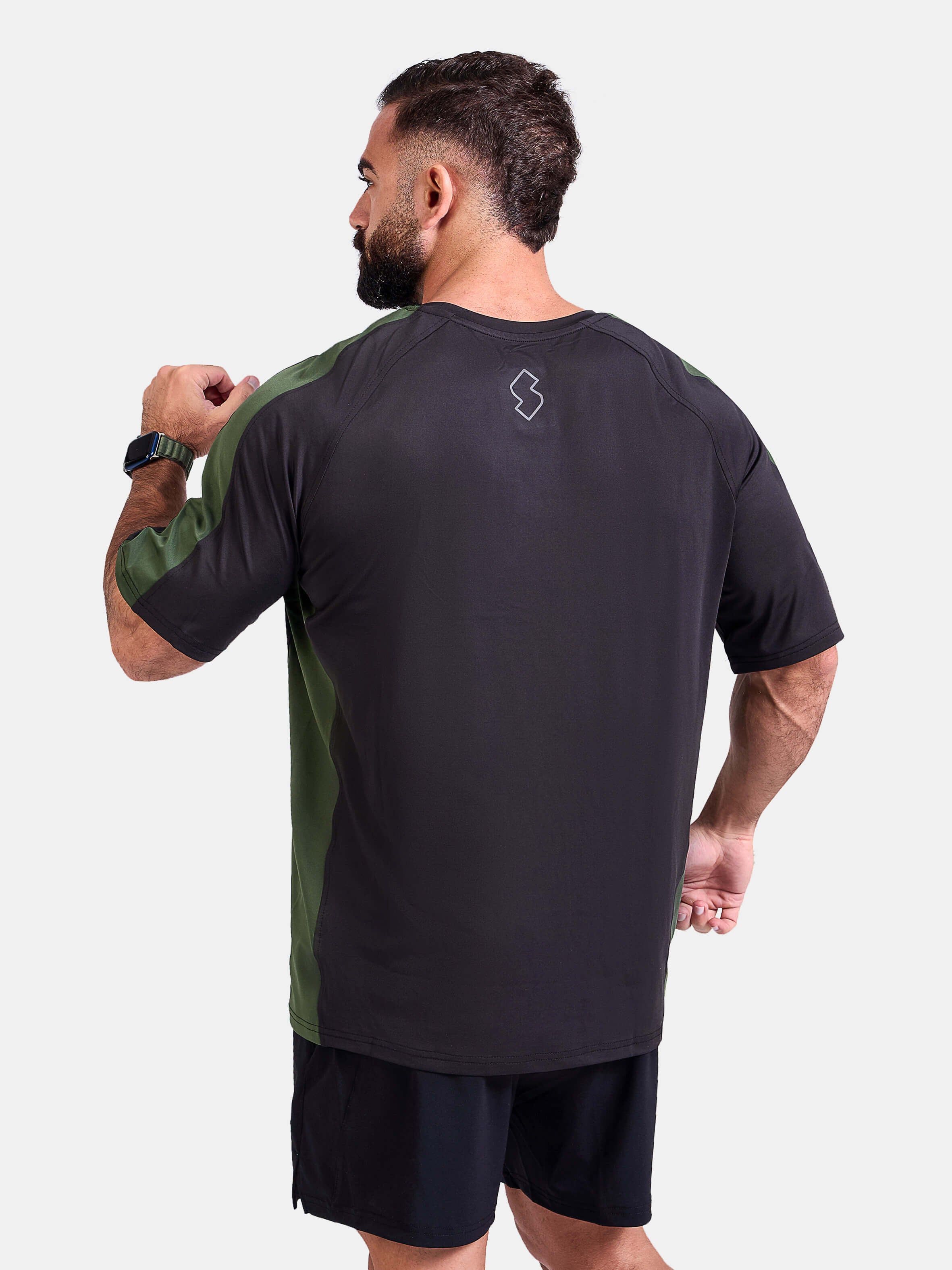 Man wearing a black and green oversized sports & gym shirt by KAF