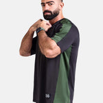 Man wearing a black and green oversized sports & gym shirt by KAF
