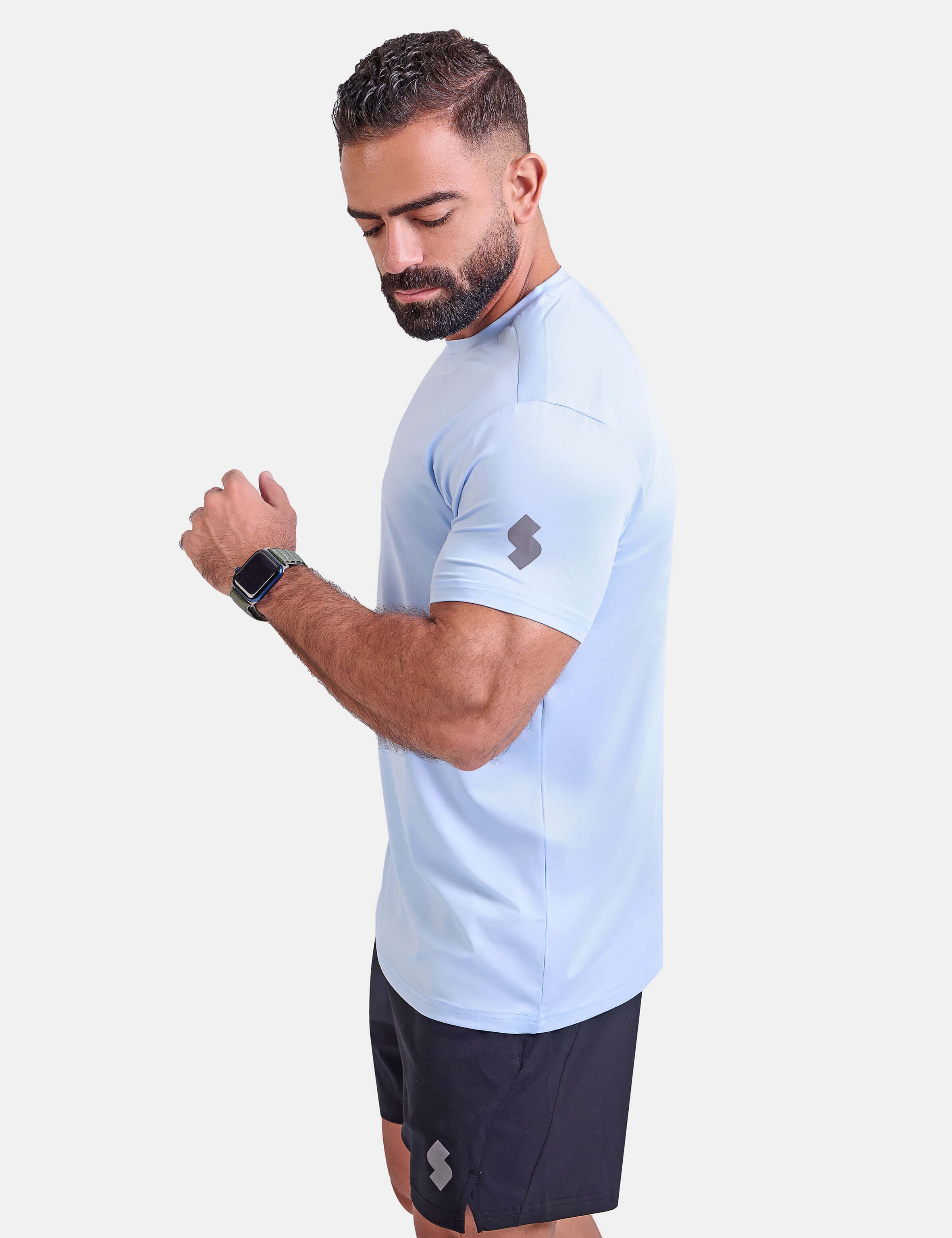 Man wearing light blue sports - gym - padel t-shirt by KAF Egypt