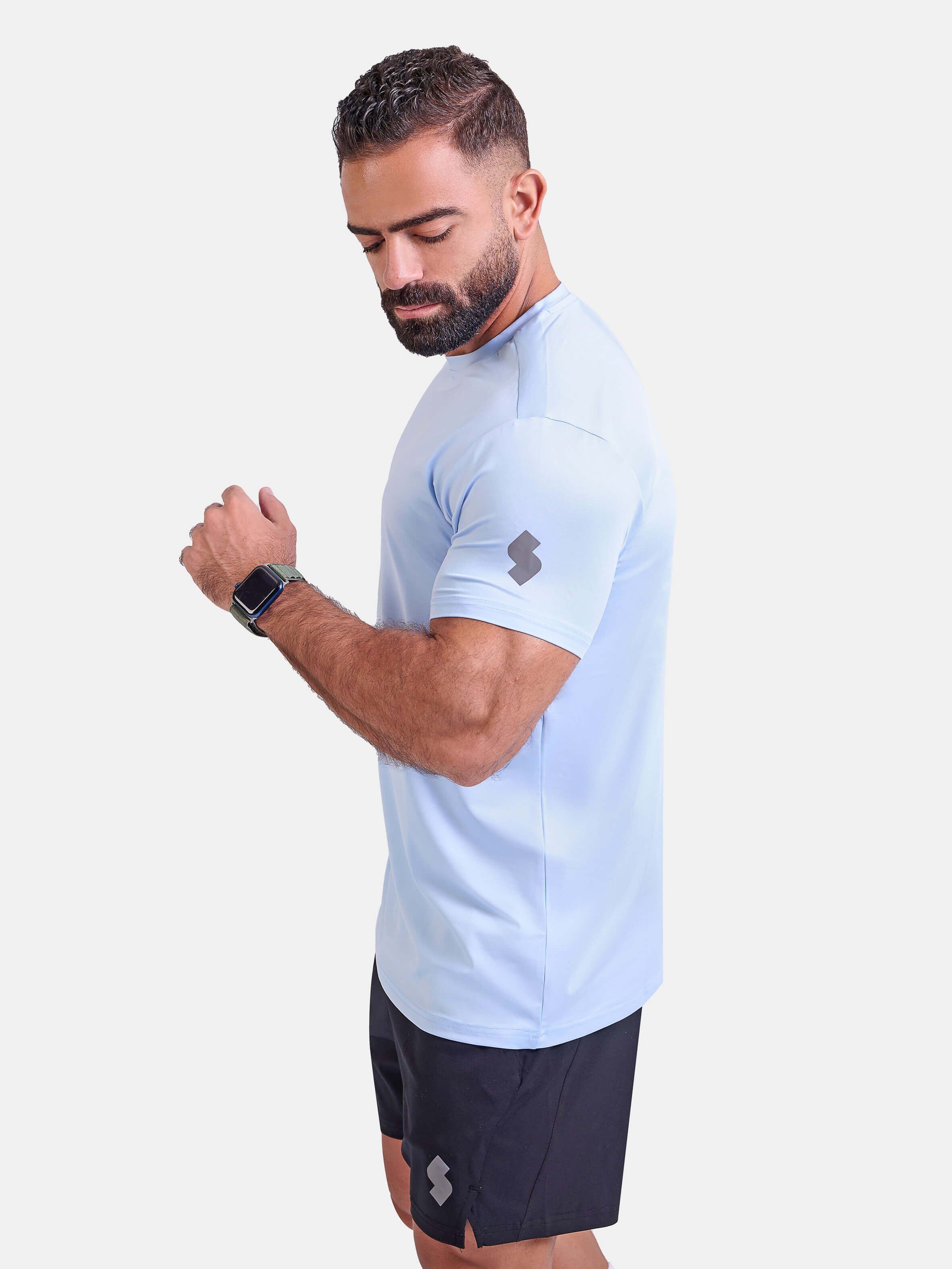 Man wearing light blue sports - gym - padel t-shirt by KAF Egypt