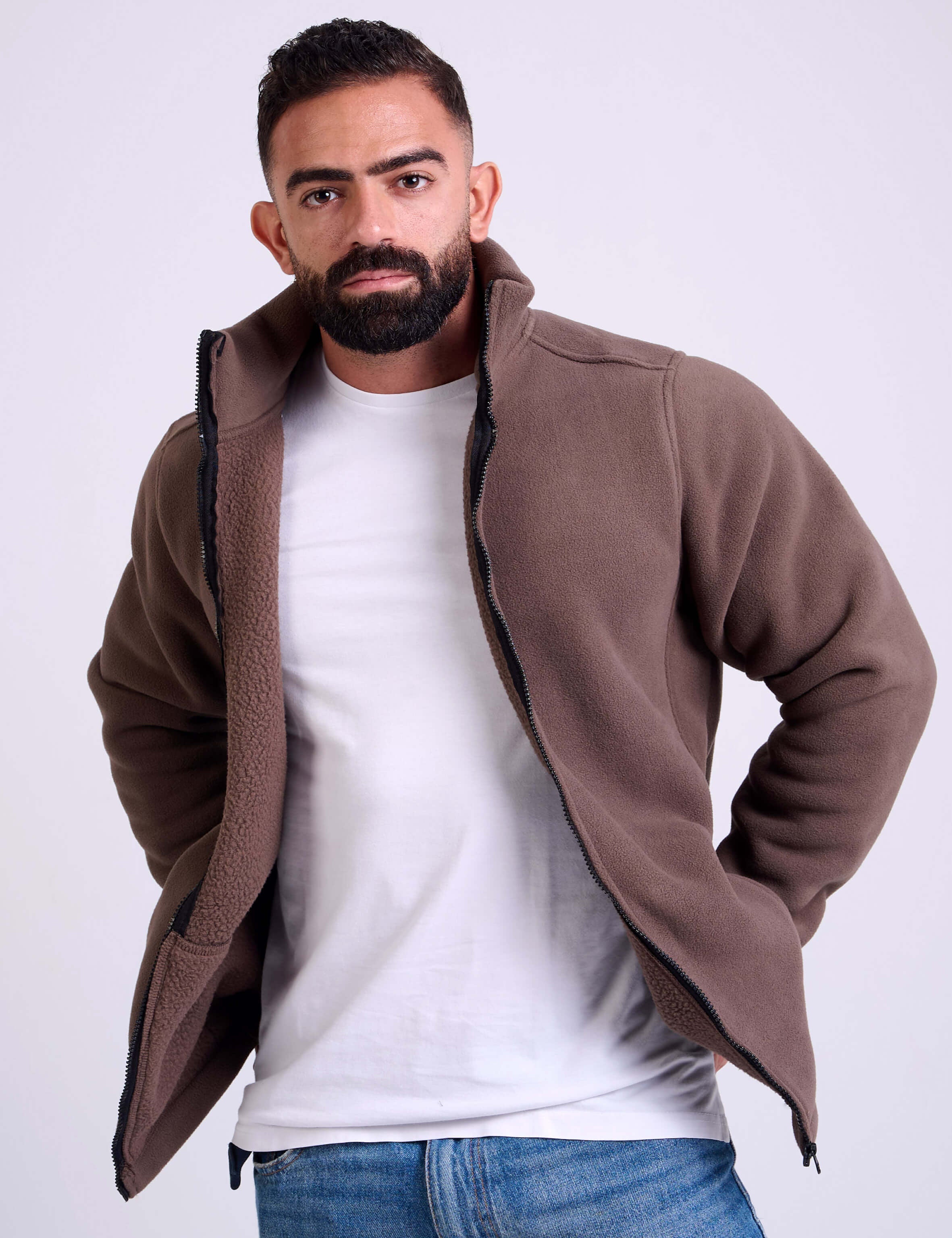 Man wearing a brown fleece jacket by KAF on a white background. Made in Egypt