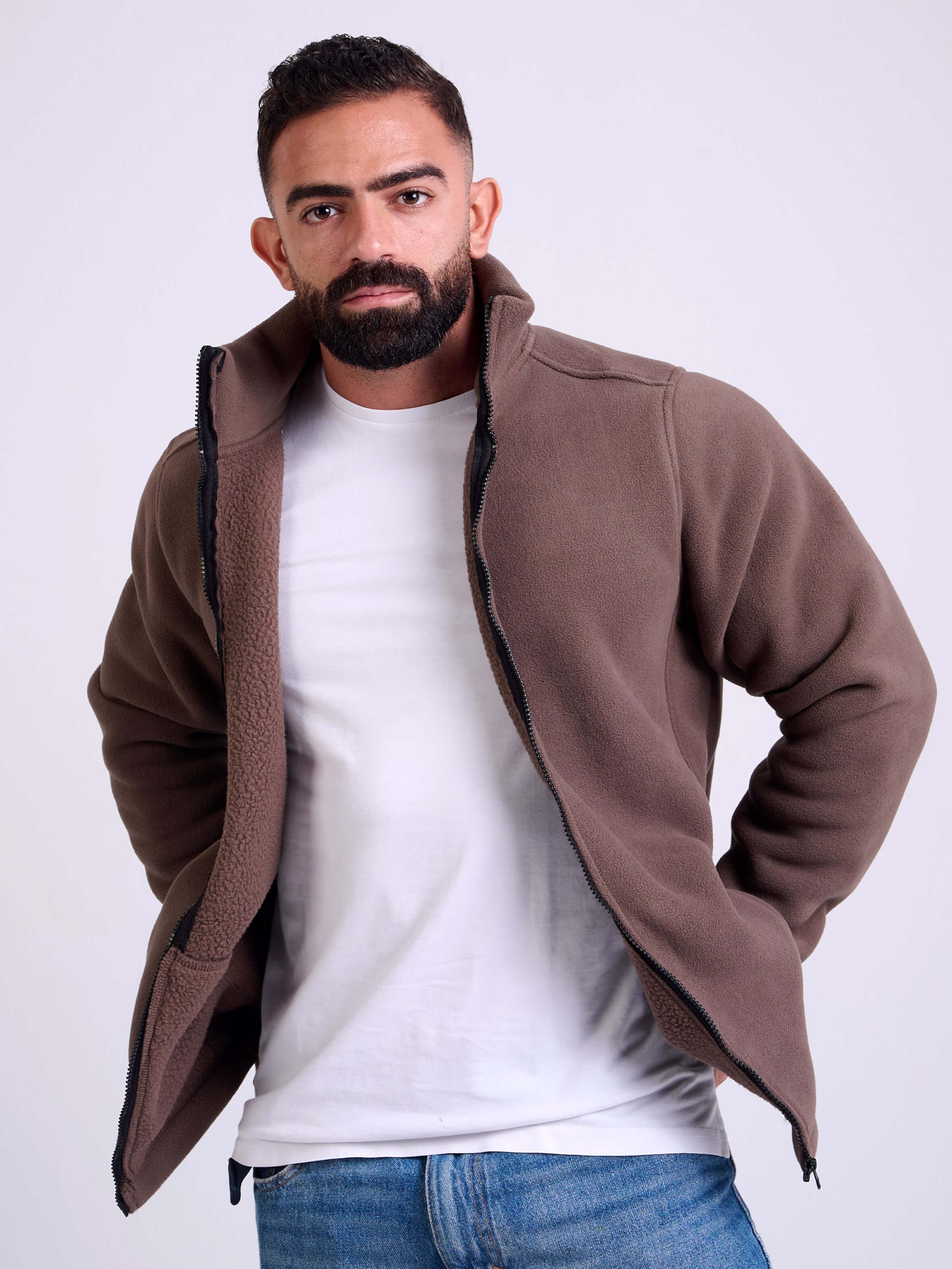Man wearing a brown fleece jacket by KAF on a white background. Made in Egypt