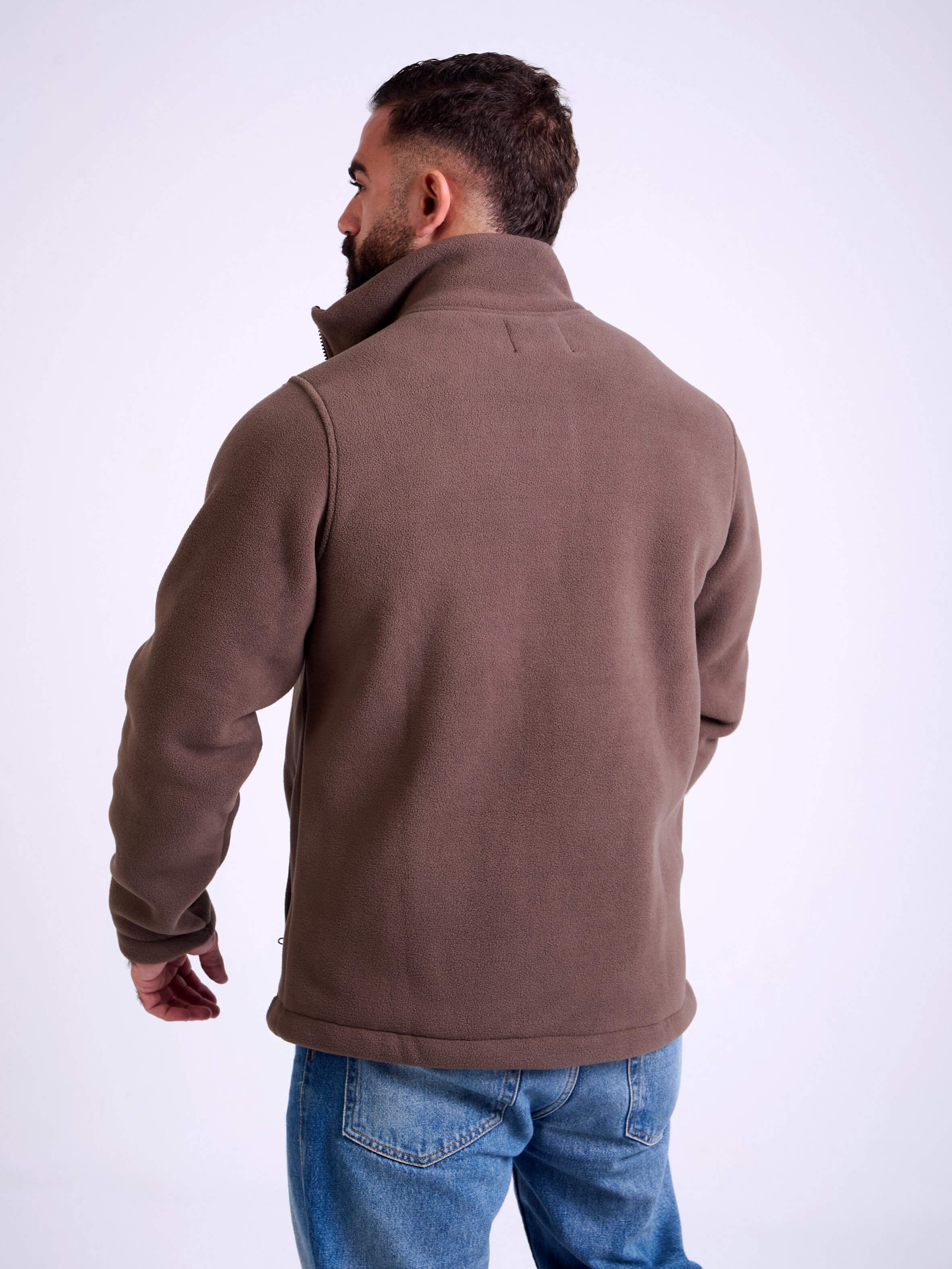 Man wearing a brown fleece jacket by KAF on a white background. Made in Egypt