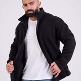 Man wearing a black fleece jacket by KAF on a white background. Made in Egypt