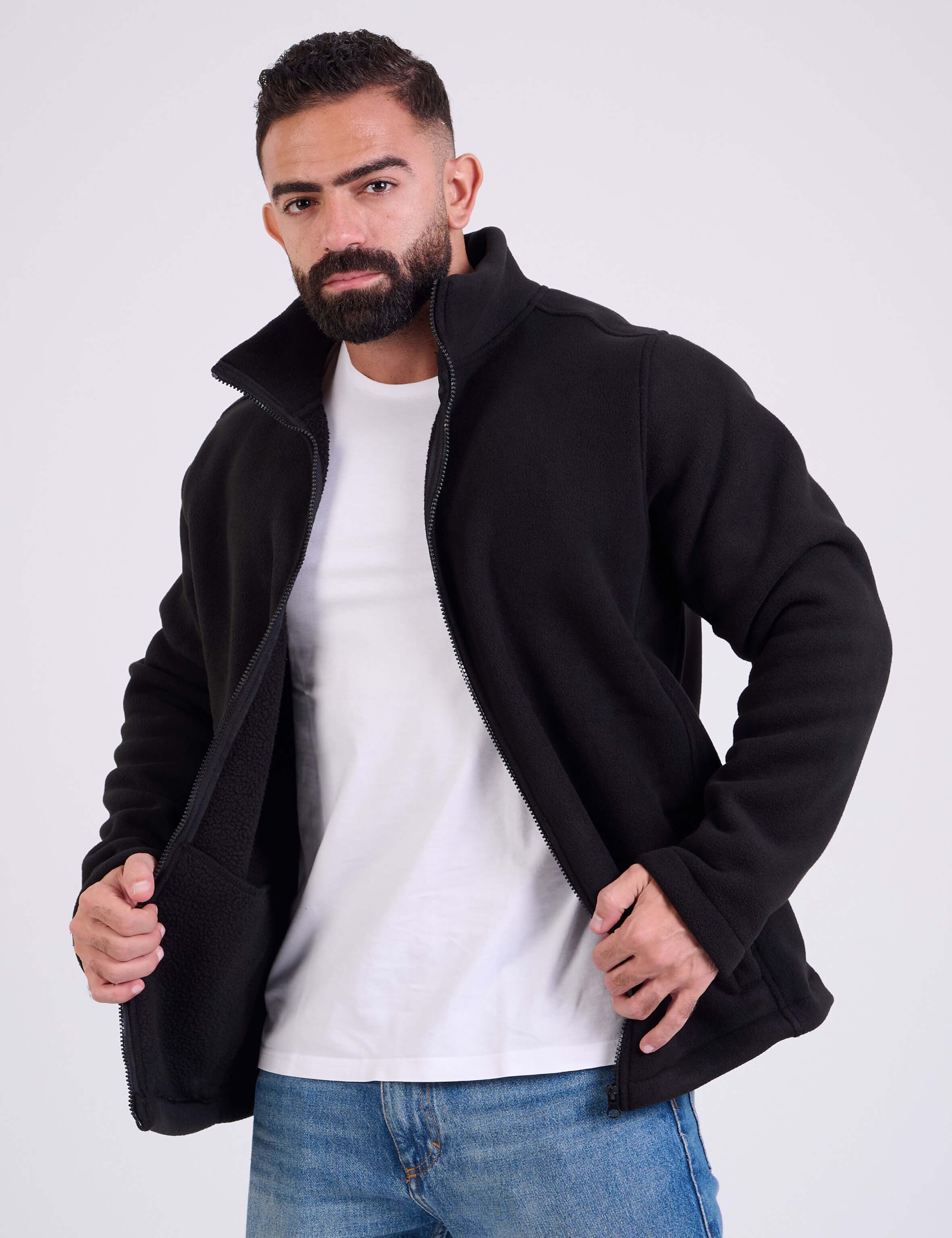 Man wearing a black fleece jacket by KAF on a white background. Made in Egypt