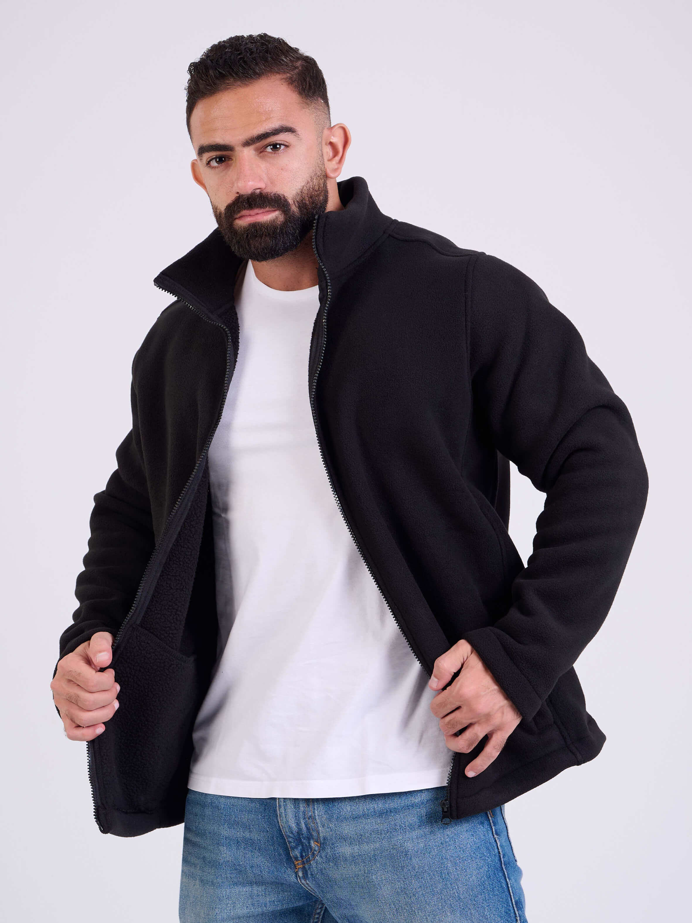 Man wearing a black fleece jacket by KAF on a white background. Made in Egypt