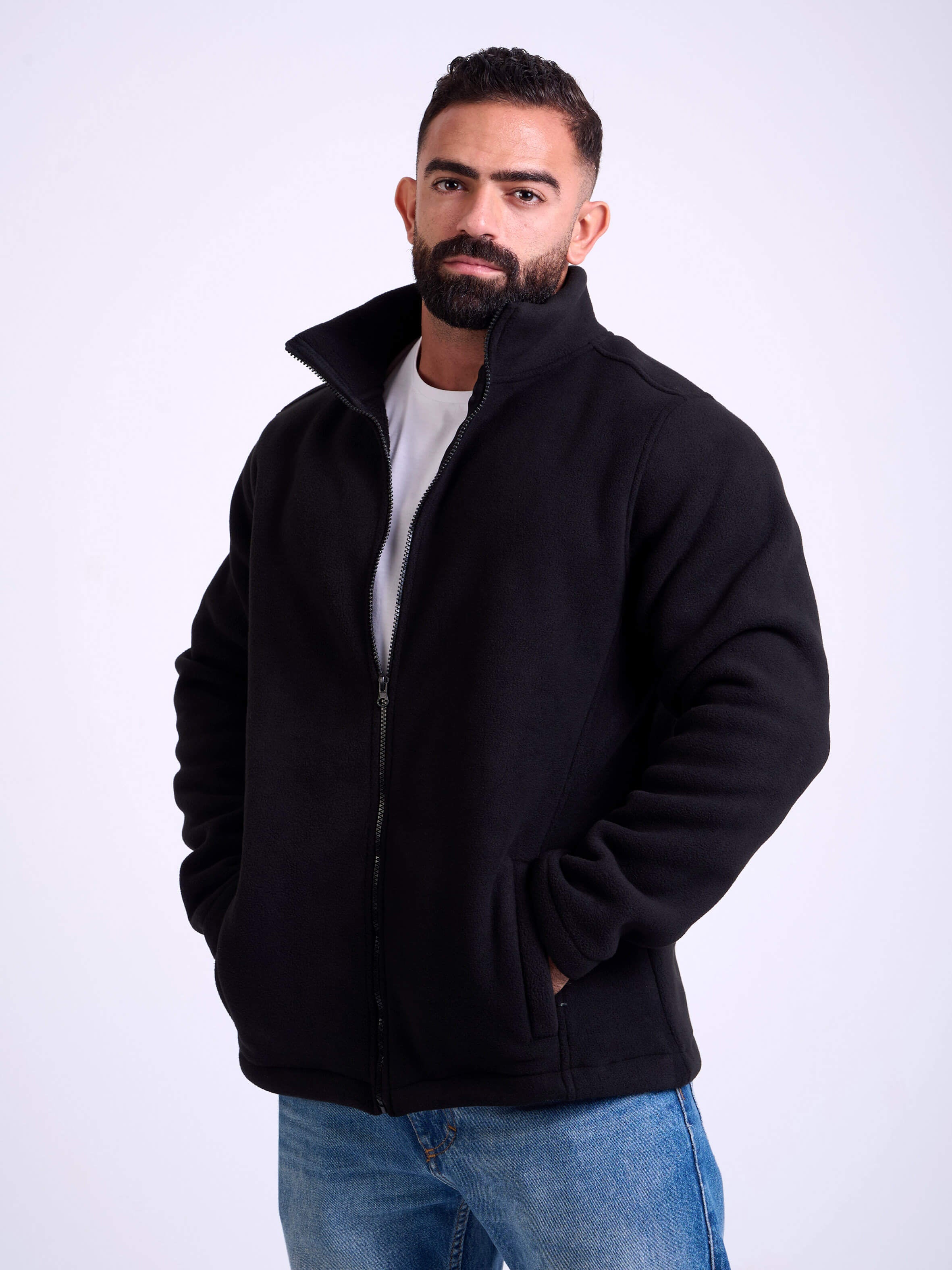 Man wearing a black fleece jacket by KAF on a white background. Made in Egypt