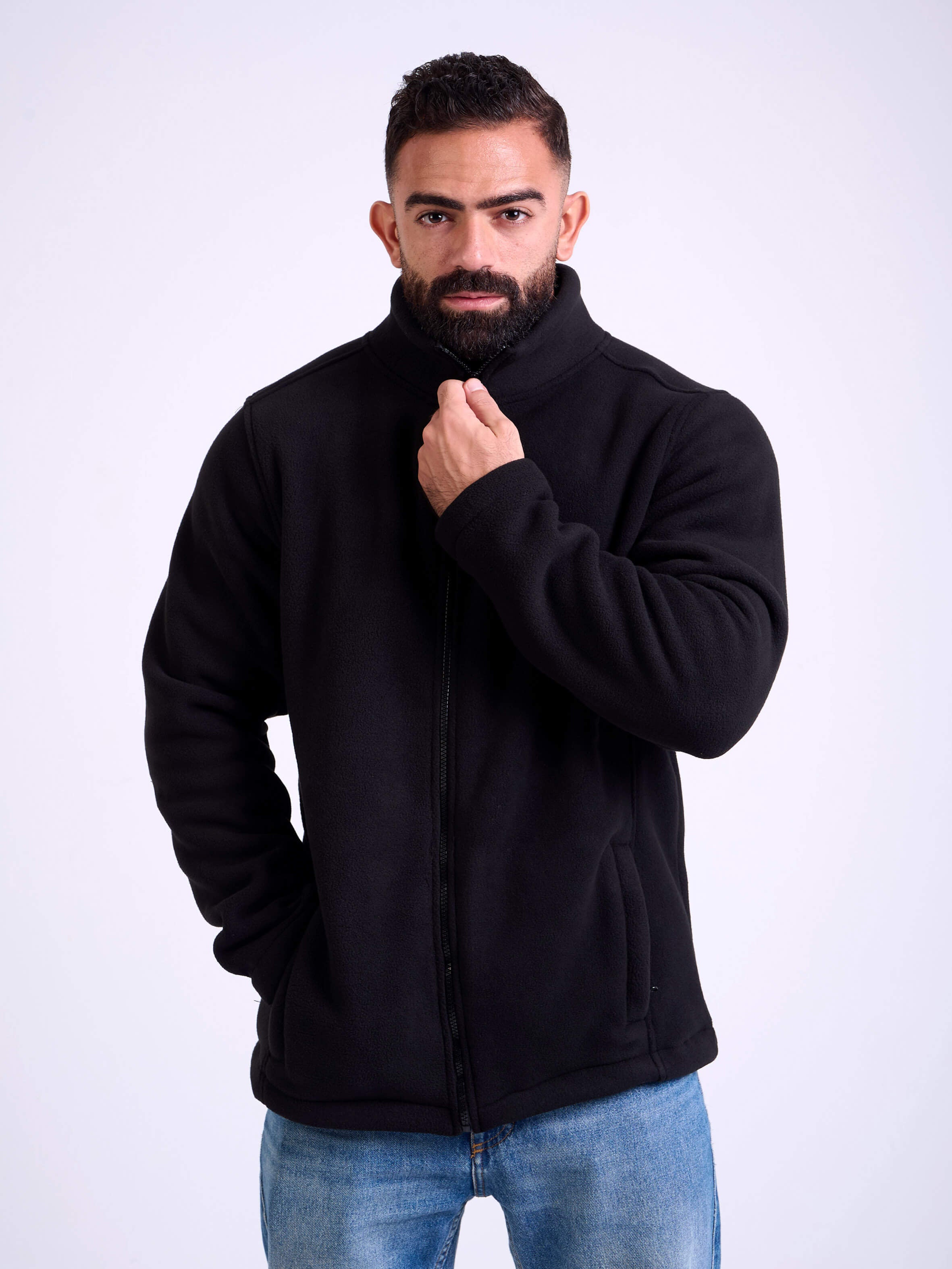 Man wearing a black fleece jacket by KAF on a white background. Made in Egypt