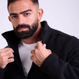 Man wearing a black fleece jacket by KAF on a white background. Made in Egypt