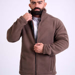 Man wearing a brown fleece jacket by KAF on a white background. Made in Egypt