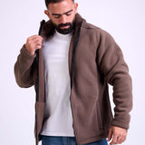 Man wearing a brown fleece jacket by KAF on a white background. Made in Egypt