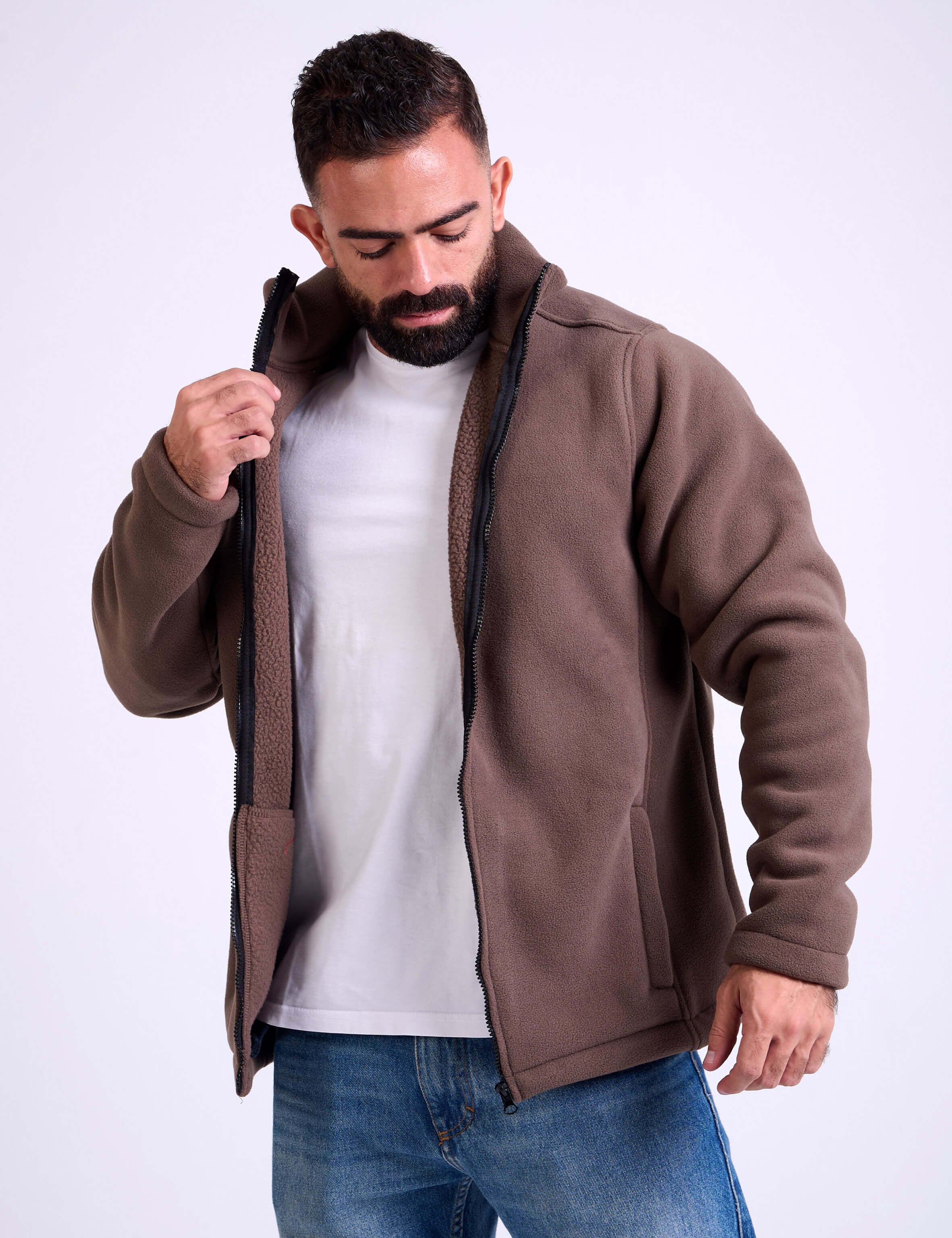Man wearing a brown fleece jacket by KAF on a white background. Made in Egypt