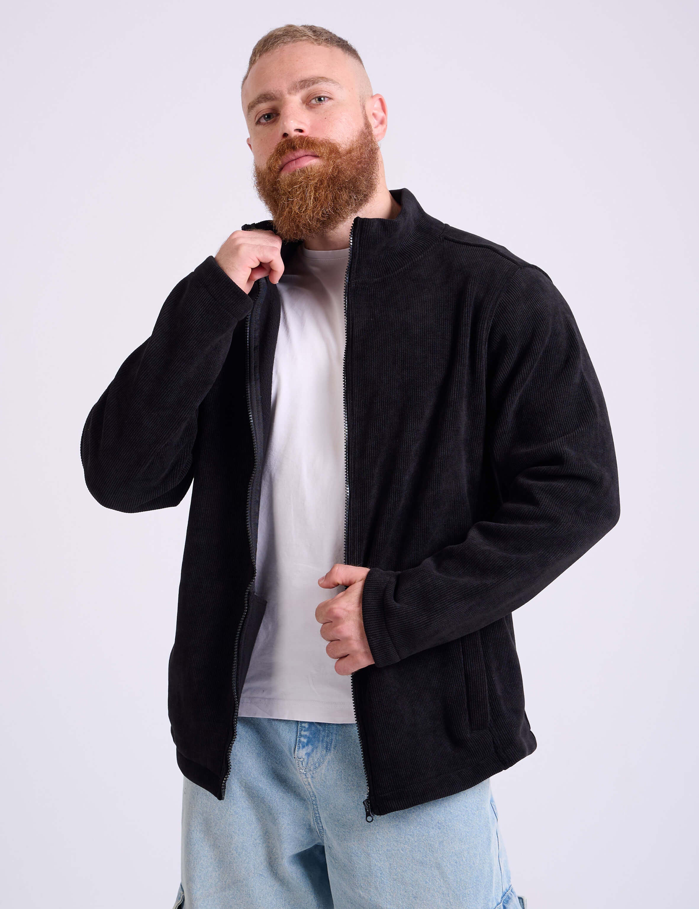 Man wearing a black corduroy jacket by KAF on a white background