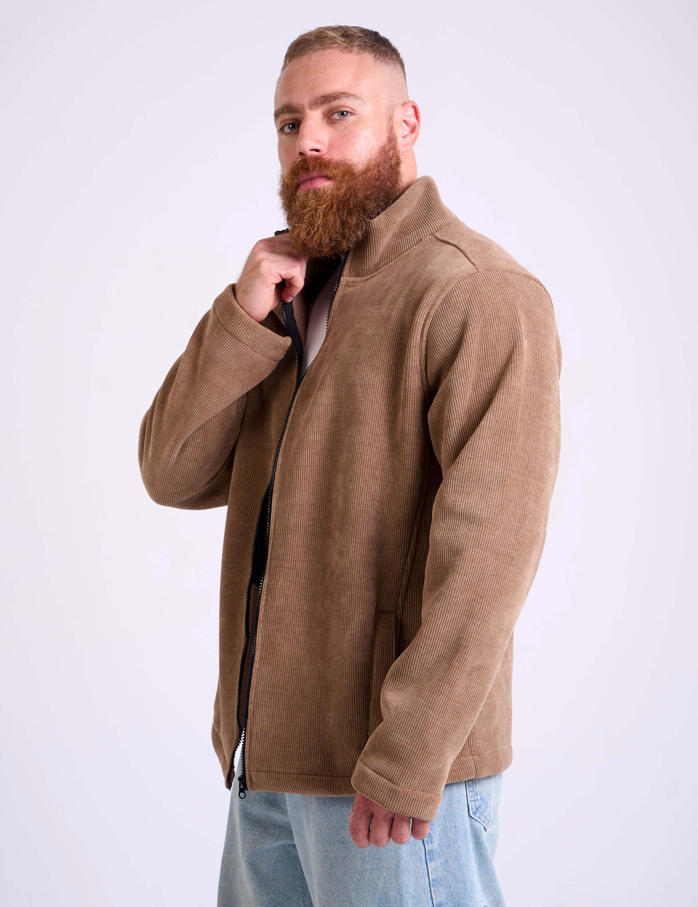Man wearing a camel beige corduroy jacket by KAF on a white background