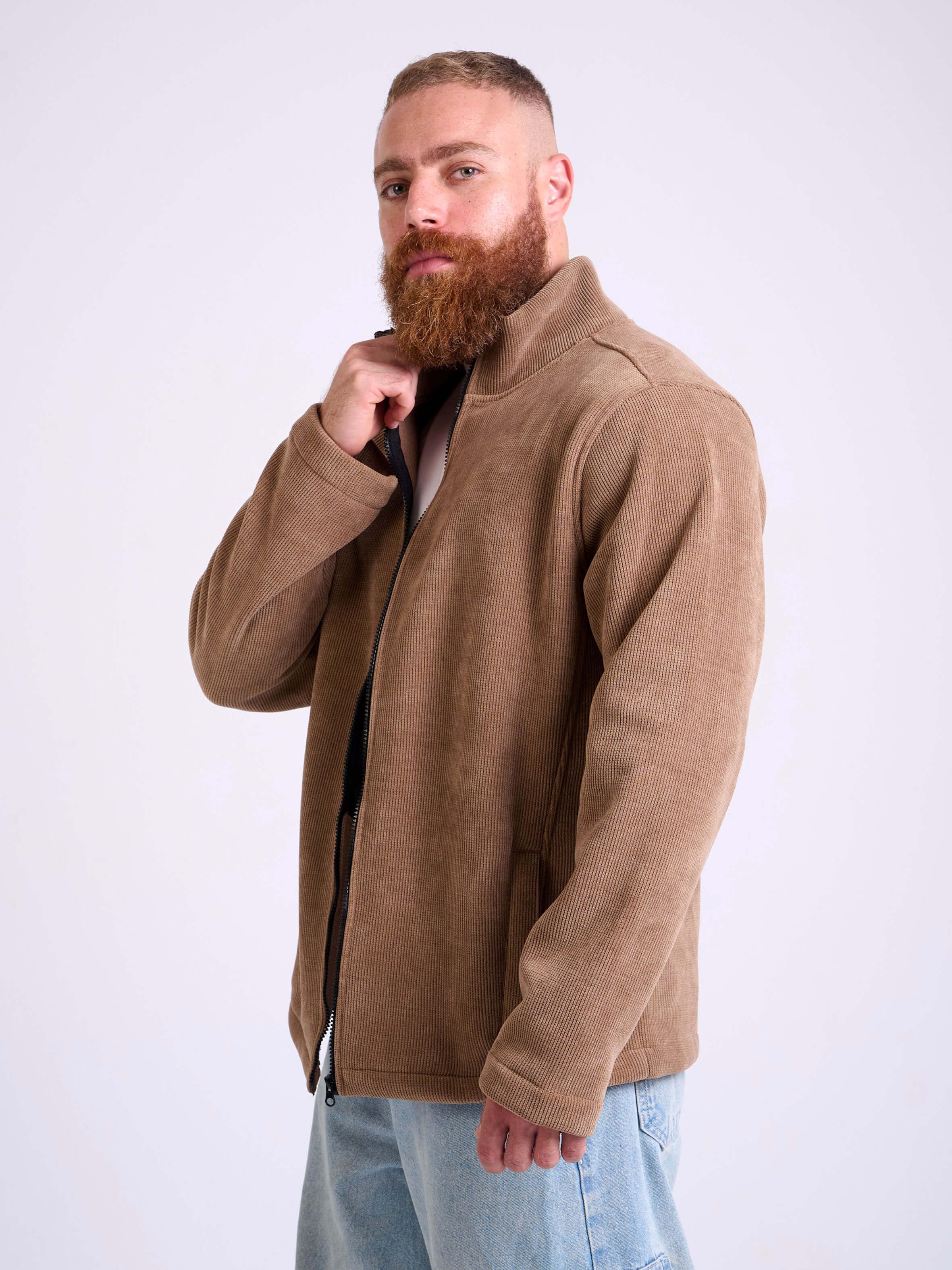 Man wearing a camel beige corduroy jacket by KAF on a white background