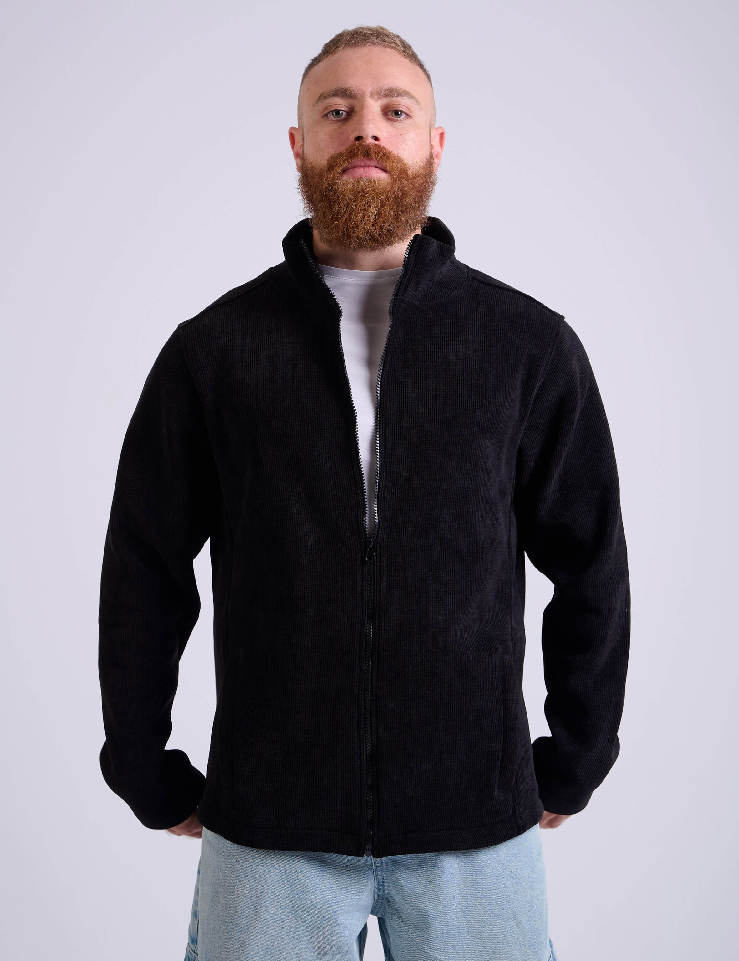 Man wearing a black corduroy jacket by KAF on a white background