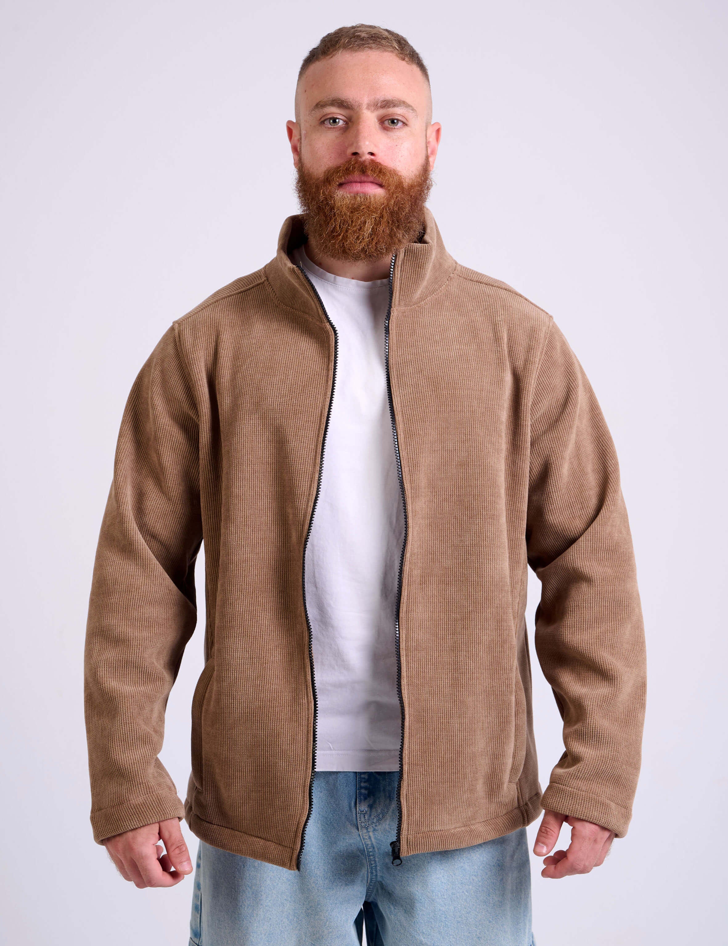 Man wearing a camel beige corduroy jacket on a white background