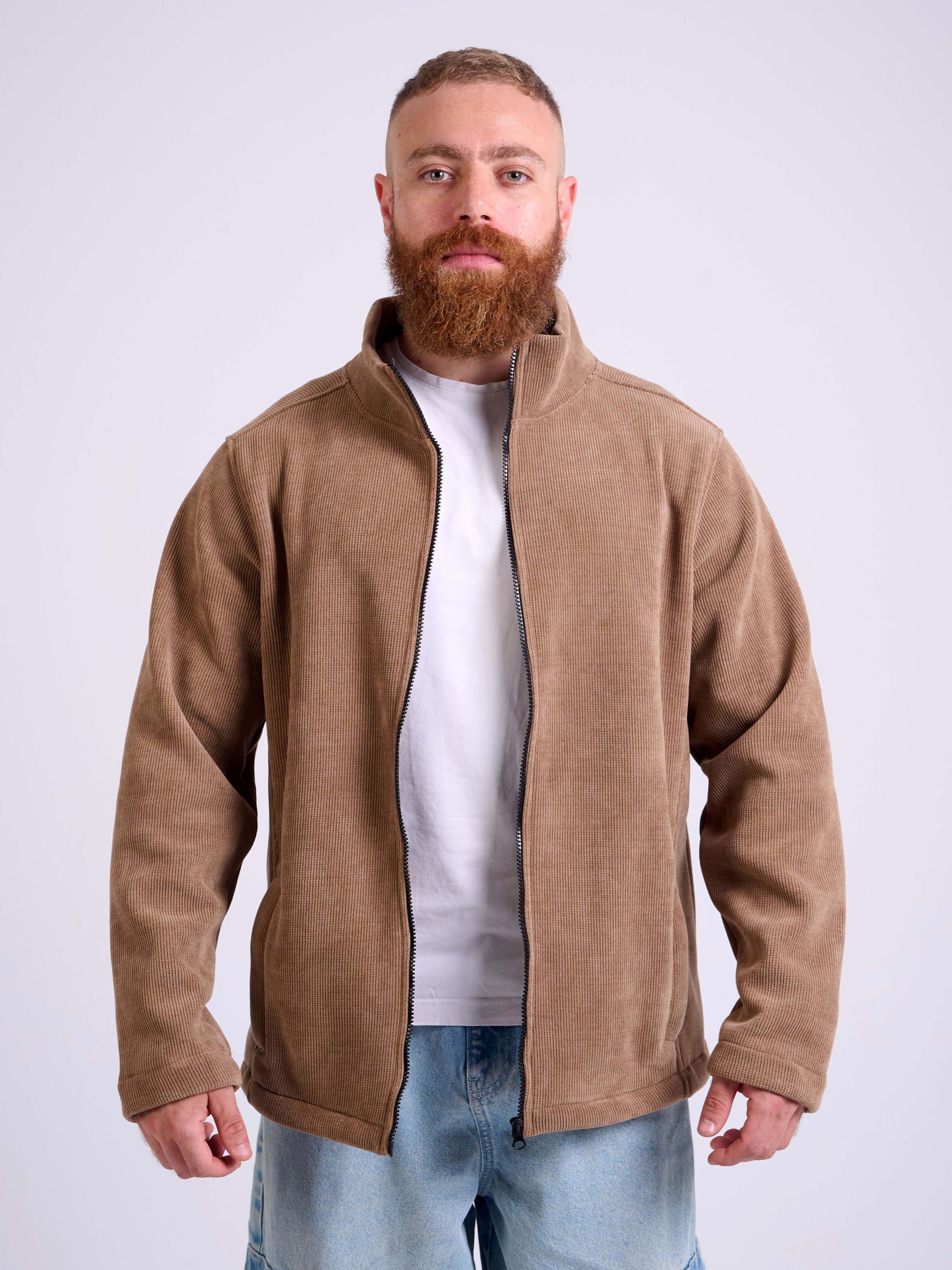 Man wearing a camel beige corduroy jacket on a white background