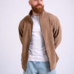 Man wearing a camel beige corduroy jacket on a white background