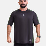 Man wearing a black and green oversized sports & gym shirt by KAF 
