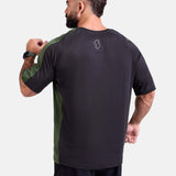 Man wearing a black and green oversized sports & gym shirt by KAF 