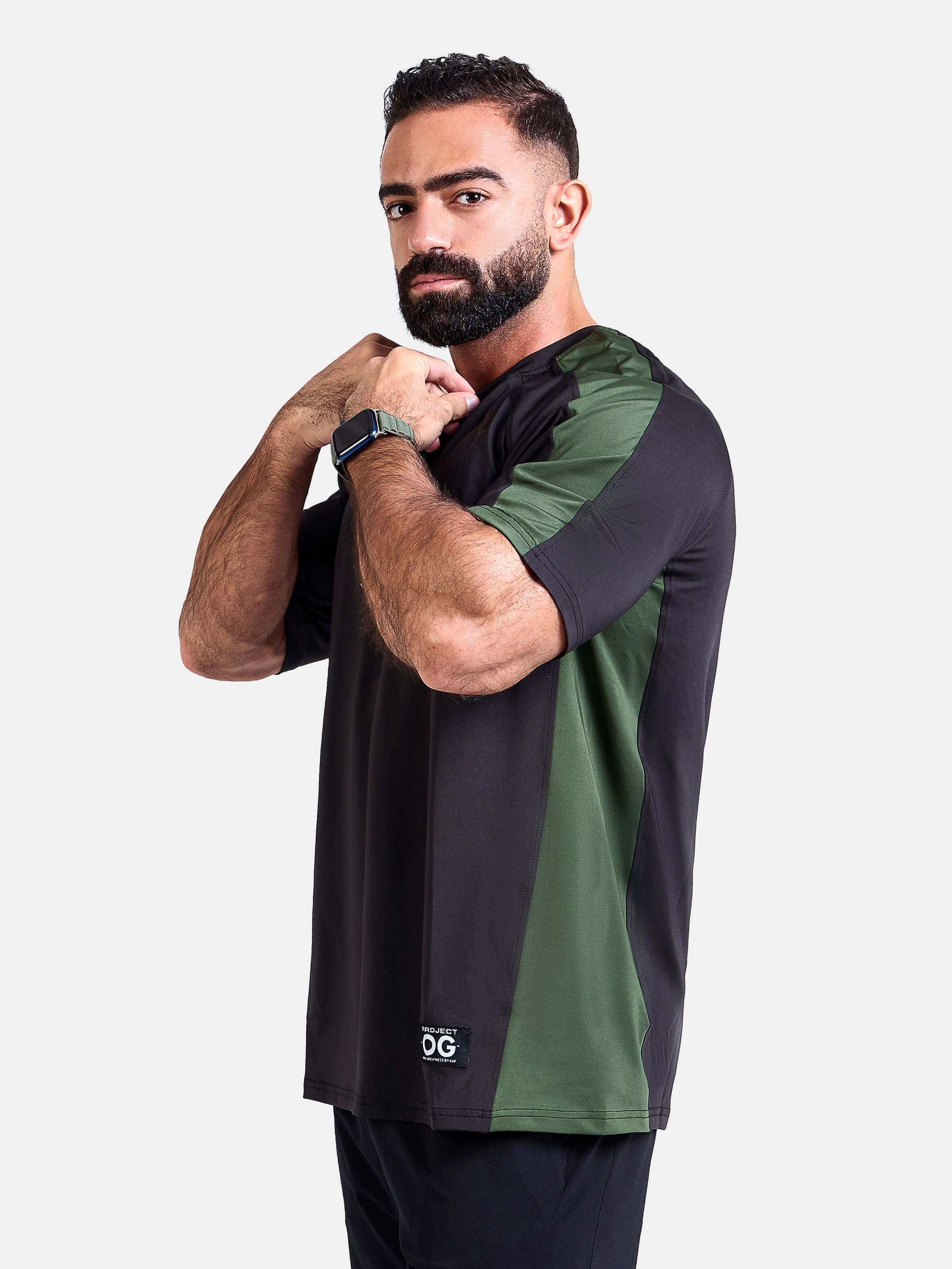 Man wearing a black and green oversized sports & gym shirt by KAF 