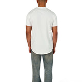 A male model wearing a white raw-edged cotton crew neck t-shirt with short sleeves and a rounded hem.