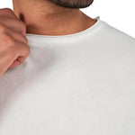 A male model wearing a white raw-edged cotton crew neck t-shirt with short sleeves and a rounded hem.