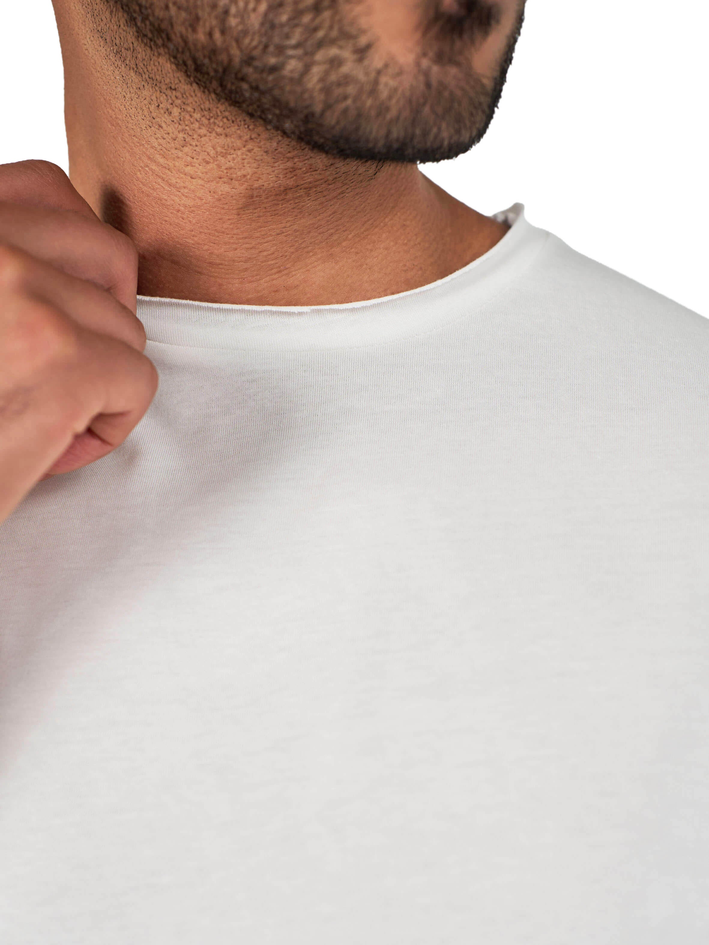 A male model wearing a white raw-edged cotton crew neck t-shirt with short sleeves and a rounded hem.