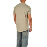 A male model wearing a raw-edged cotton crew neck t-shirt with short sleeves and a rounded hem.
