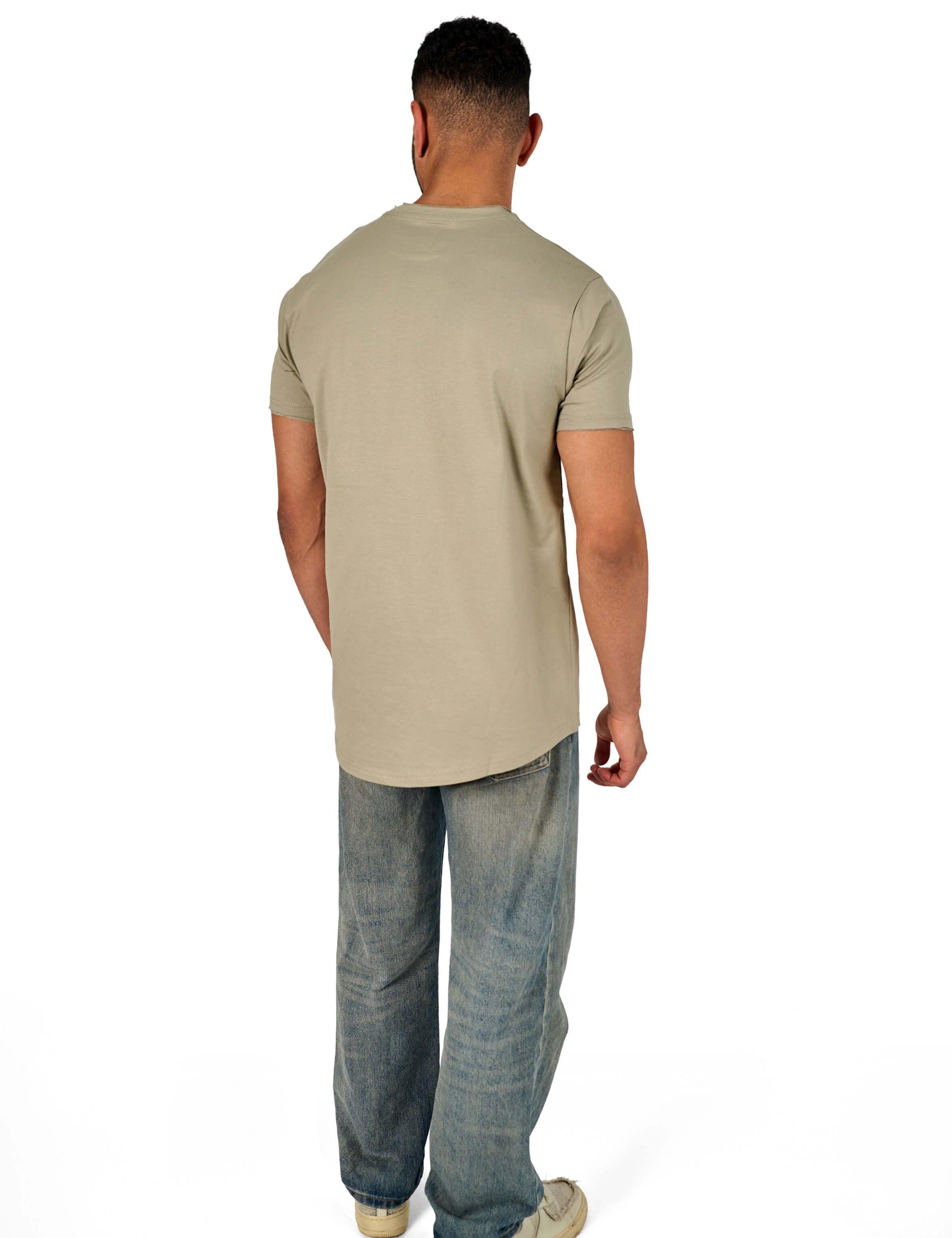 A male model wearing a raw-edged cotton crew neck t-shirt with short sleeves and a rounded hem.