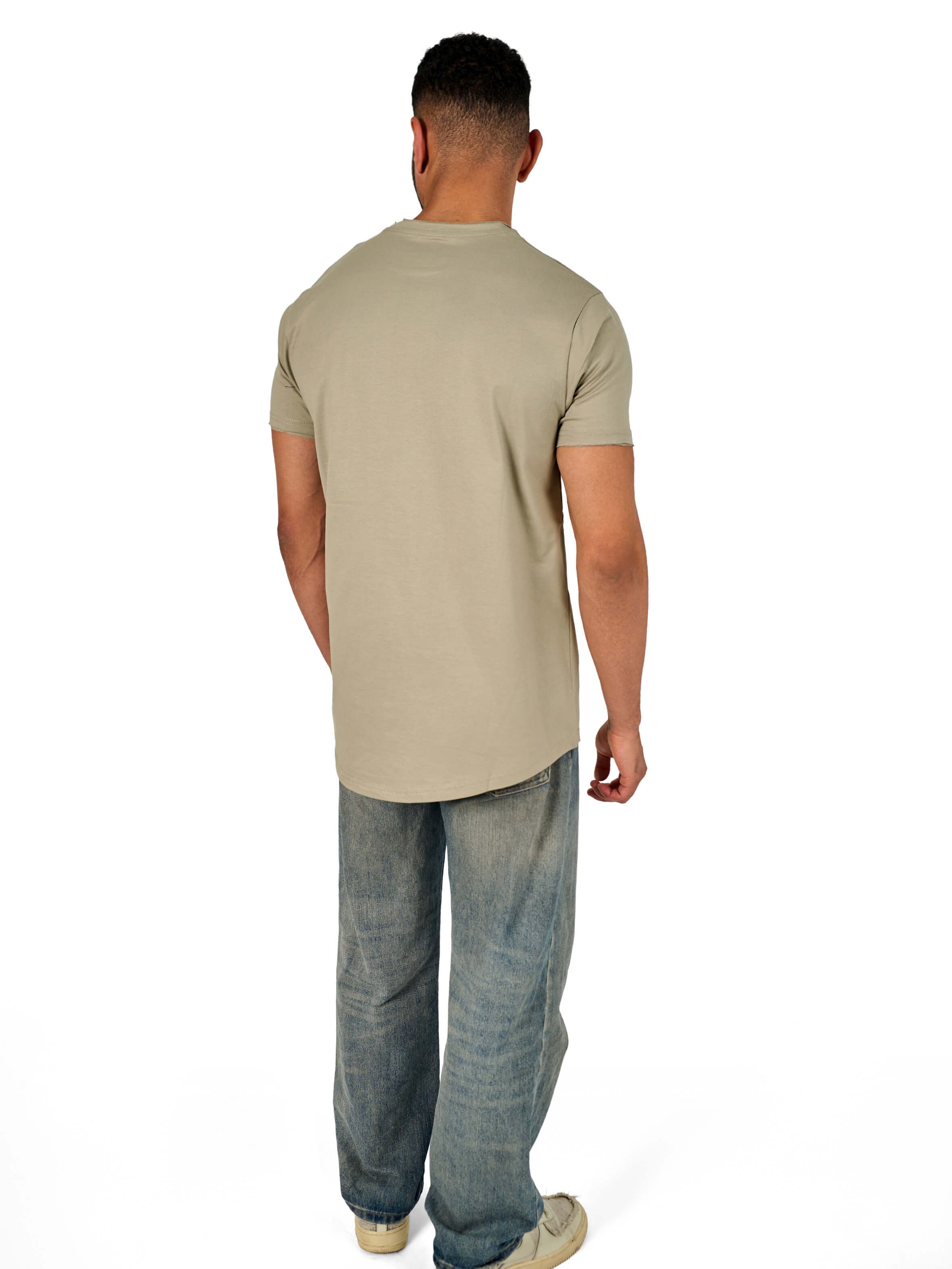 A male model wearing a raw-edged cotton crew neck t-shirt with short sleeves and a rounded hem.