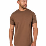 A male model wearing a raw-edged cotton crew neck t-shirt with short sleeves and a rounded hem.