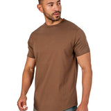 A male model wearing a raw-edged cotton crew neck t-shirt with short sleeves and a rounded hem.
