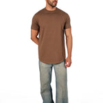 A male model wearing a raw-edged cotton crew neck t-shirt with short sleeves and a rounded hem.