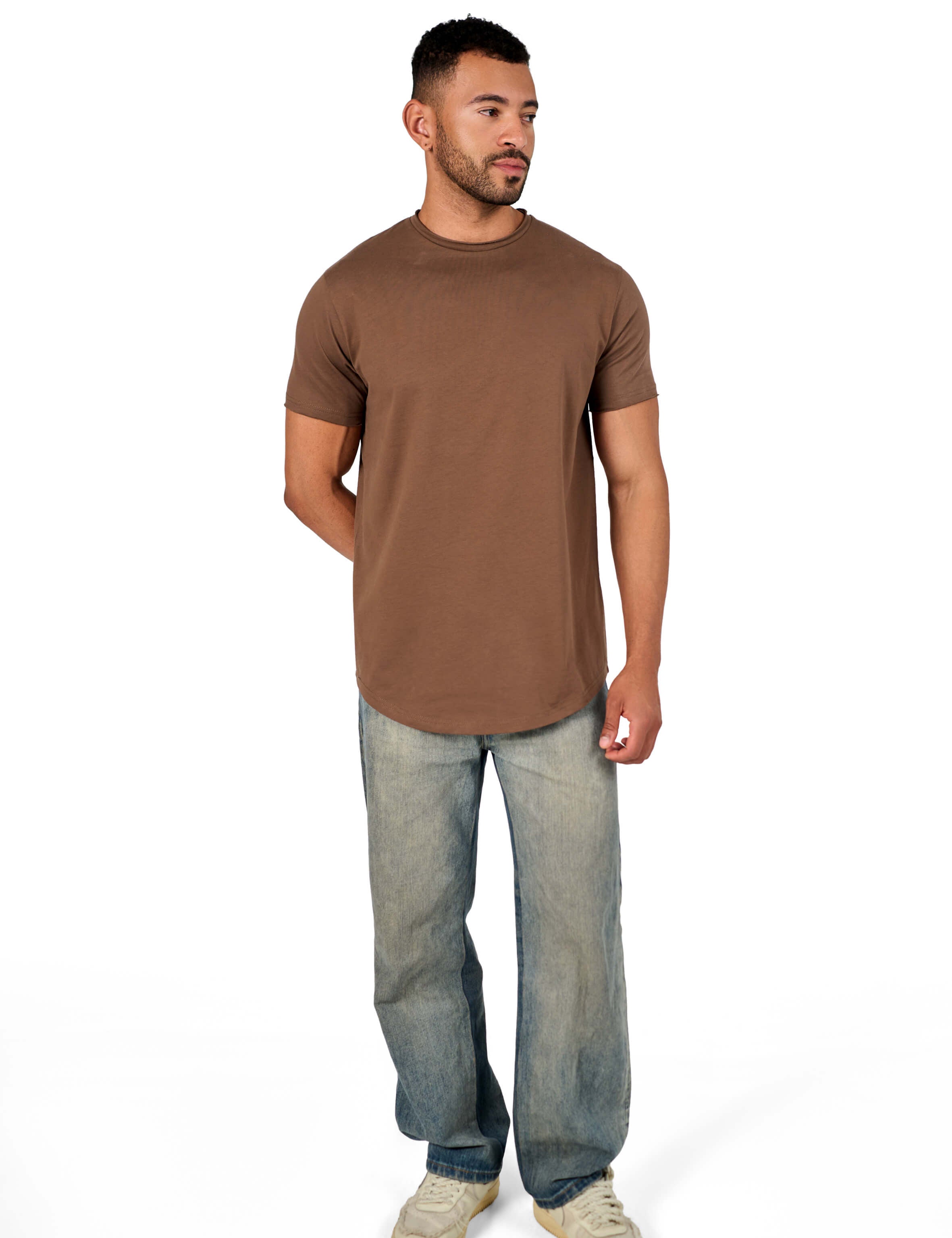 A male model wearing a raw-edged cotton crew neck t-shirt with short sleeves and a rounded hem.