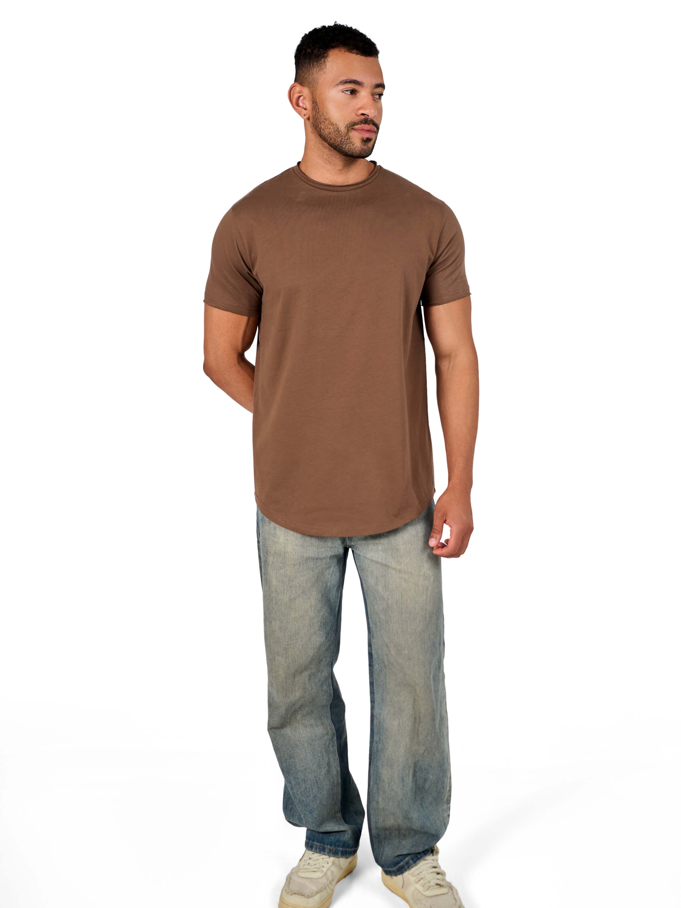 A male model wearing a raw-edged cotton crew neck t-shirt with short sleeves and a rounded hem.