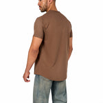 A male model wearing a raw-edged cotton crew neck t-shirt with short sleeves and a rounded hem.