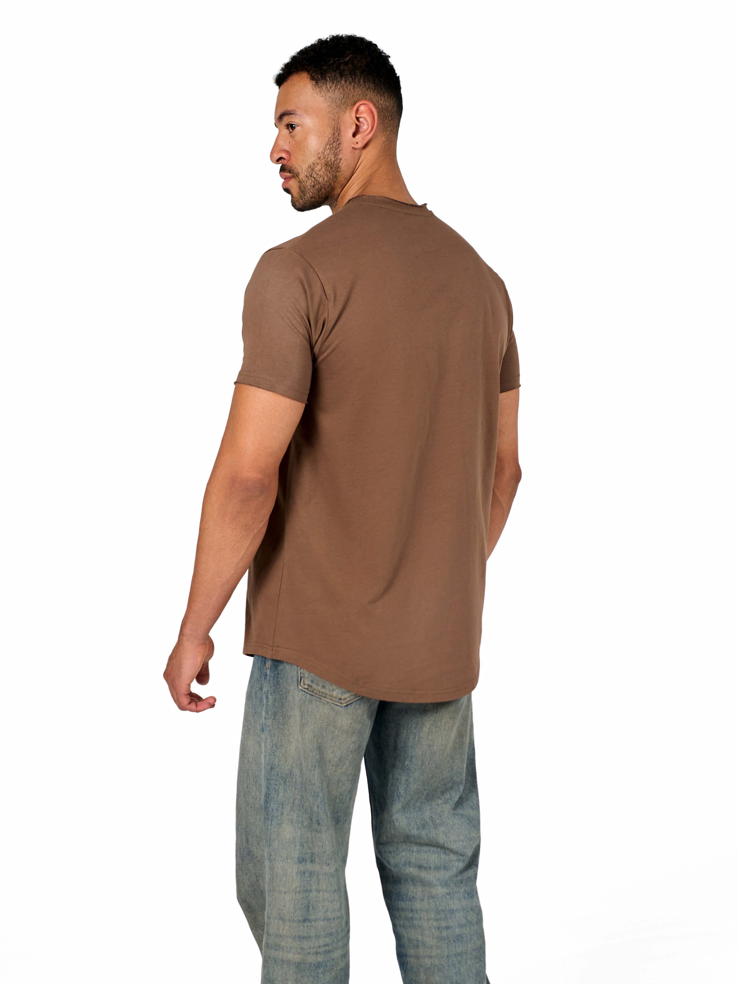 A male model wearing a raw-edged cotton crew neck t-shirt with short sleeves and a rounded hem.