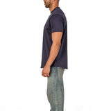 A male model wearing a raw-edged cotton crew neck t-shirt with short sleeves and a rounded hem.