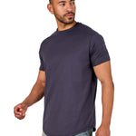 A male model wearing a raw-edged cotton crew neck t-shirt with short sleeves and a rounded hem.